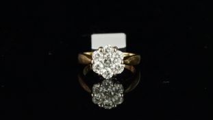 Diamond daisy cluster ring, seven round brilliant cut diamonds weighing an estimated total of 1.