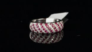 Ruby and diamond bombÃ© band ring, set with diagonal rows of round cut rubies and round brilliant