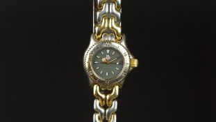 LADIES' TAG HEUER WRISTWATCH, circular grey dial with luminous hands and a date aperture, 24mm