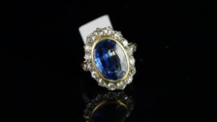 Blue stone and diamond cluster ring, oval cut blue stone surrounded by old cut diamonds and