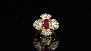French ruby and diamond cluster ring, central oval cut ruby measuring approximately 8.30 x 7.05mm,
