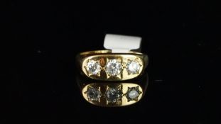 Gentlemen's three stone diamond ring, three round brilliant cut diamonds, in star settings,