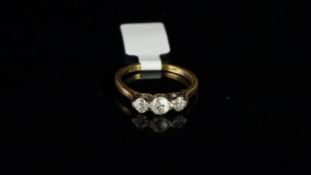 Three stone diamond ring, three old cut diamonds, claw set in white metal on a yellow metal shank