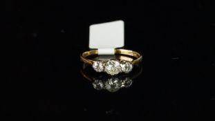 Three stone diamond ring, three old cut diamonds, claw set in white metal on a yellow metal shank