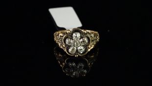 Georgian mourning ring, five old mine cut diamonds in a floral motif, surrounded by black enamel,
