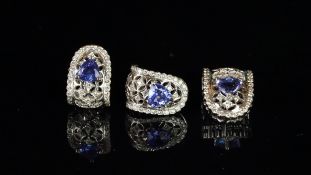 Tanzanite pendant and earrings suite, pendant designed as a trilliant cut tanzanite within an