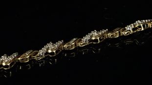 A diamond bracelet, alternating links of baguette cut diamonds in a twist link and round brilliant