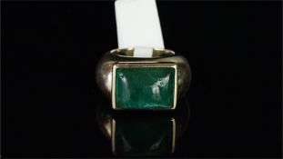 Single stone emerald ring, rectangular cabochon emerald, rubover set in yellow gold, bearing