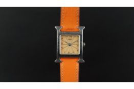 LADIES' HERMES WRISTWATCH, square salmon dial with silver Arabic and baton hour markers in a 19mm