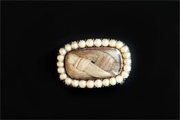 Georgian mourning brooch, central hair compartment, with a border of split pearls, the reverse is