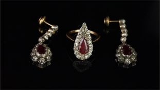 A pair of ruby and diamond drop earrings, pear cut ruby surrounded by old cut diamonds, suspended