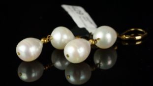 A pair of freshwater pearl earrings, two pearls set from a yellow metal hook, stamped 14k