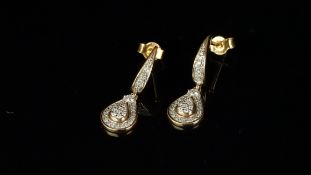 A pair of diamond cluster earrings, round brilliant cut diamonds in a pear shaped drop, from a