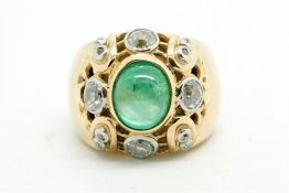 Emerald and diamond ring, central cabochon cut emerald measuring 9.45 x 7.41 x 5.66mm, with an old