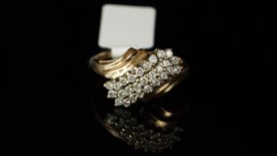 Diamond cluster ring, round brilliant cut diamonds, in a twist motif, weighing an estimated total of