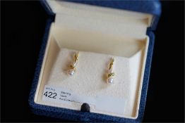 Pair of Mikimoto earrings, each set with two pearls, measuring an estimated 5 and 3.5mm, set