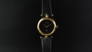 LADIES' GUCCI WRISTWATCH, circular black dial with gold dauphine hands, 22mm plated case with