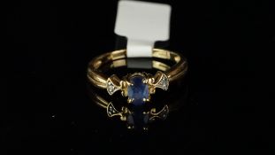 Sapphire and diamond ring, central oval cut sapphire, with a diamond set to each shoulder, mounted