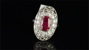 French ruby and diamond ring, oval cut ruby measuring 11.3 x 7.8mm, surrounded by round brilliant