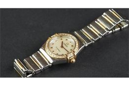LADIES' OMEGA CONSTELLATION, circular white dial, with gold bevelled hour markers, diamond bezel, on