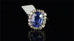 Sapphire and diamond cluster ring, oval cut sapphire weighing an estimated 7.50ct, surrounded by old
