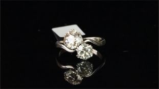 Two stone diamond crossover ring, one old cut white diamond weighing an estimated 0.75ct and one old