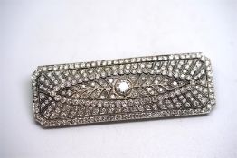 Diamond panel brooch, set with a central old cut diamond weighing an estimated 0.55ct, within a