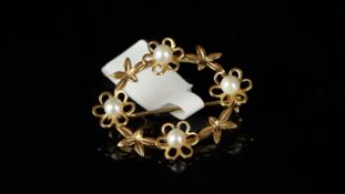9ct yellow gold pearl floral brooch, oval open brooch, set with four flower motifs centrally set