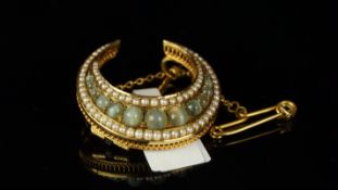 Cats-eye chrysoberyl and pearl crescent brooch, graduated cats-eye chrysoberyl, surrounded by seed
