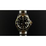 GENTLEMEN'S ROLEX OYSTER PERPETUAL DATE SUBMARINER REF 16613, circular black dial with gold framed