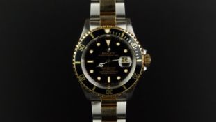 GENTLEMEN'S ROLEX OYSTER PERPETUAL DATE SUBMARINER REF 16613, circular black dial with gold framed