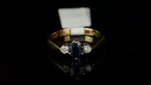 Three stone sapphire and diamond ring, mounted in hallmarked 9ct yellow gold, central oval sapphire,