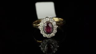 Ruby and diamond oval cluster ring, mounted in hallmarked 9ct yellow gold, central oval ruby, rub-
