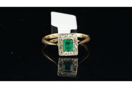 Emerald and diamond ring, central emerald surrounded by Swiss cut diamonds, mounted in yellow metal,