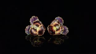 A pair of enamel and diamond pansy earrings, central round brilliant cut diamond, with purple and