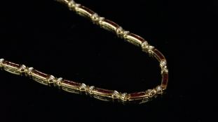 Ruby and diamond necklace, alternating links of four calibre cut rubies channel set, and two round