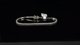 Diamond line bracelet, seventy-three round brilliant cut diamonds, claw set in white metal stamped