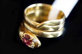 Garnet snake ring, designed as a coiled snake, with a round cut almandine garnet set to the head and