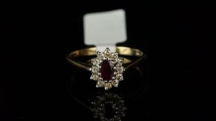 Ruby and diamond oval cluster ring, mounted in hallmarked 9ct yellow gold, central oval ruby,