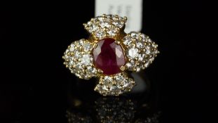 French ruby and diamond cluster ring, central oval cut ruby measuring approximately 8.30 x 7.05mm,