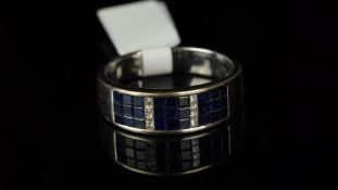 Sapphire and diamond ring, calibre cut sapphires set in 3 x 3 blocks, each separated by a row of