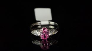 Three stone pink and white stone ring, mounted in hallmarked 9ct white gold, central oval pink