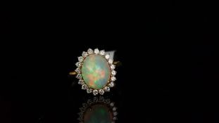 Opal and diamond ring, oval cabochon cut opal measuring approximately 12.44 x 10.05 x 7.79mm,