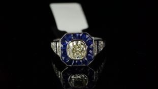 Art Deco style sapphire and diamond ring, central cushion shaped fancy cut diamond, surrounded by