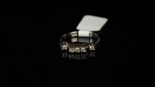 Five stone diamond ring, designed with three central diamonds in high settings, with a lower set