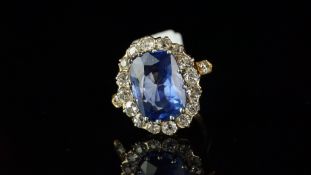 Burma sapphire and diamond cluster ring, mounted in yellow metal, French eagle's head stamped to the