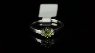 Five stone peridot and diamond ring, mounted in hallmarked 9ct white gold, central oval peridot,