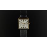 GENTLEMEN'S UNIVERSAL GENEVE WRISTWATCH CIRCA 1964, square silver dial with golf and black hour