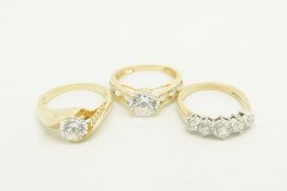 Three cubic zirconia rings, one set in 9ct yellow gold and two set in 14ct yellow gold