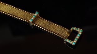 A yellow metal bracelet in the style of a belt, mesh design, with beaded edges and seed pearl and